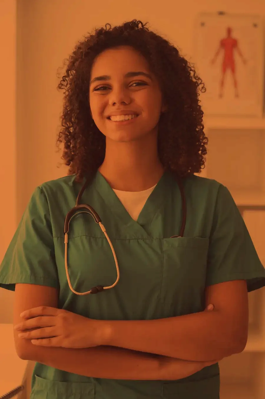 A nurse at a workstation in a hospital corridor